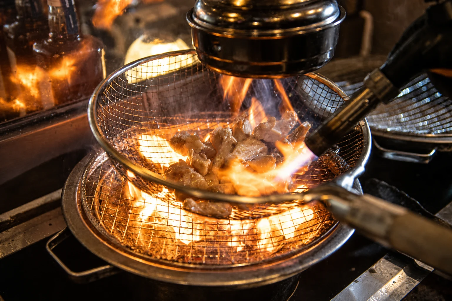 Chicken grilling in a basket over charcoal
